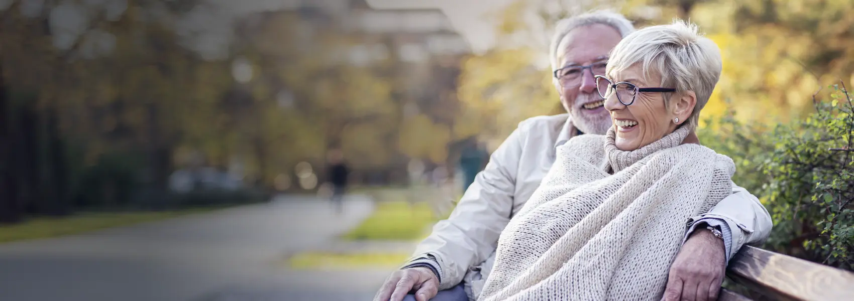 Couple sitting on bench in park area