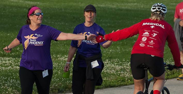 Dr. Waltke on bike with Athletes